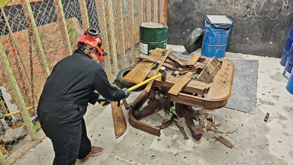 Smashing table with sledgehammer rage room San Diego